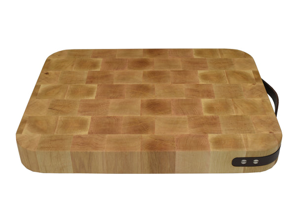 Double sided reversible wooden cutting board with leather slat handle